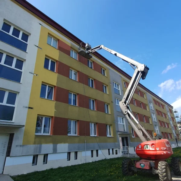 Výškové práce na čištění fasády panelového domu